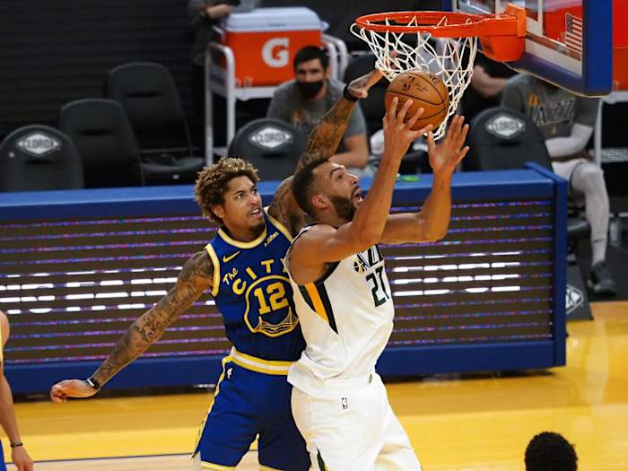 Rudy Gobert (27) goes for a layup over Kelly Oubre Jr (12)